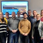 Foto einer Gruppe vor einem Bildschirm; von links: Vanessa Huber (Smart City Jena), Diethard Sahlender (Smart City Haßfurt), Stefan Bischof (Smart City Jena), Simon Dutkowski (Fraunhofer FOKUS), Juan Carlos Carvajal (Fraunhofer FOKUS), Martin Berger (Smart City Jena), Mark Hoffmann (Data in Motion, Jena), Manuela Meyer (Smart City Jena), Volker Holzendorf (Smart City Jena)
