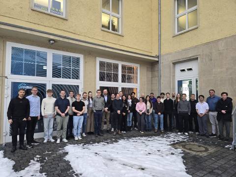 Viele Menschen schauen in die Kamera.