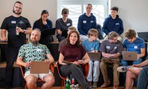 Mehrere Personen im Publikum schauen interessiert in eine Richtung.