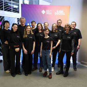 Viele Menschen schauen in die Kamera.